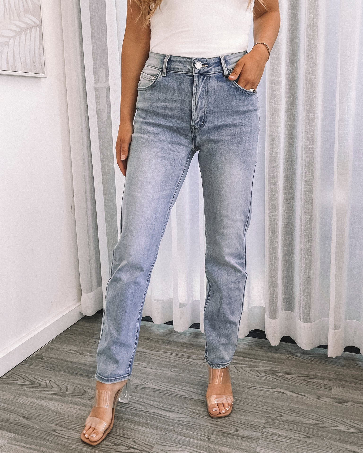 girl posing with hands on face wearing a bright orange dress
