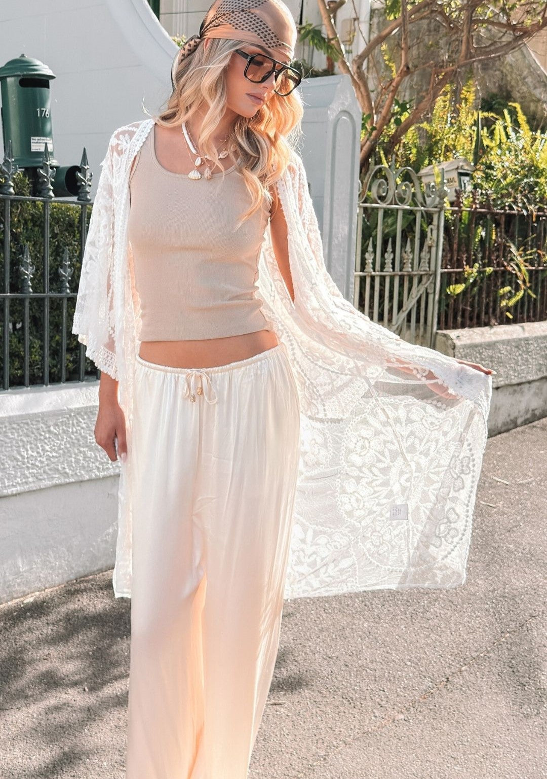 girl posing on couch wearing a bright orange dress