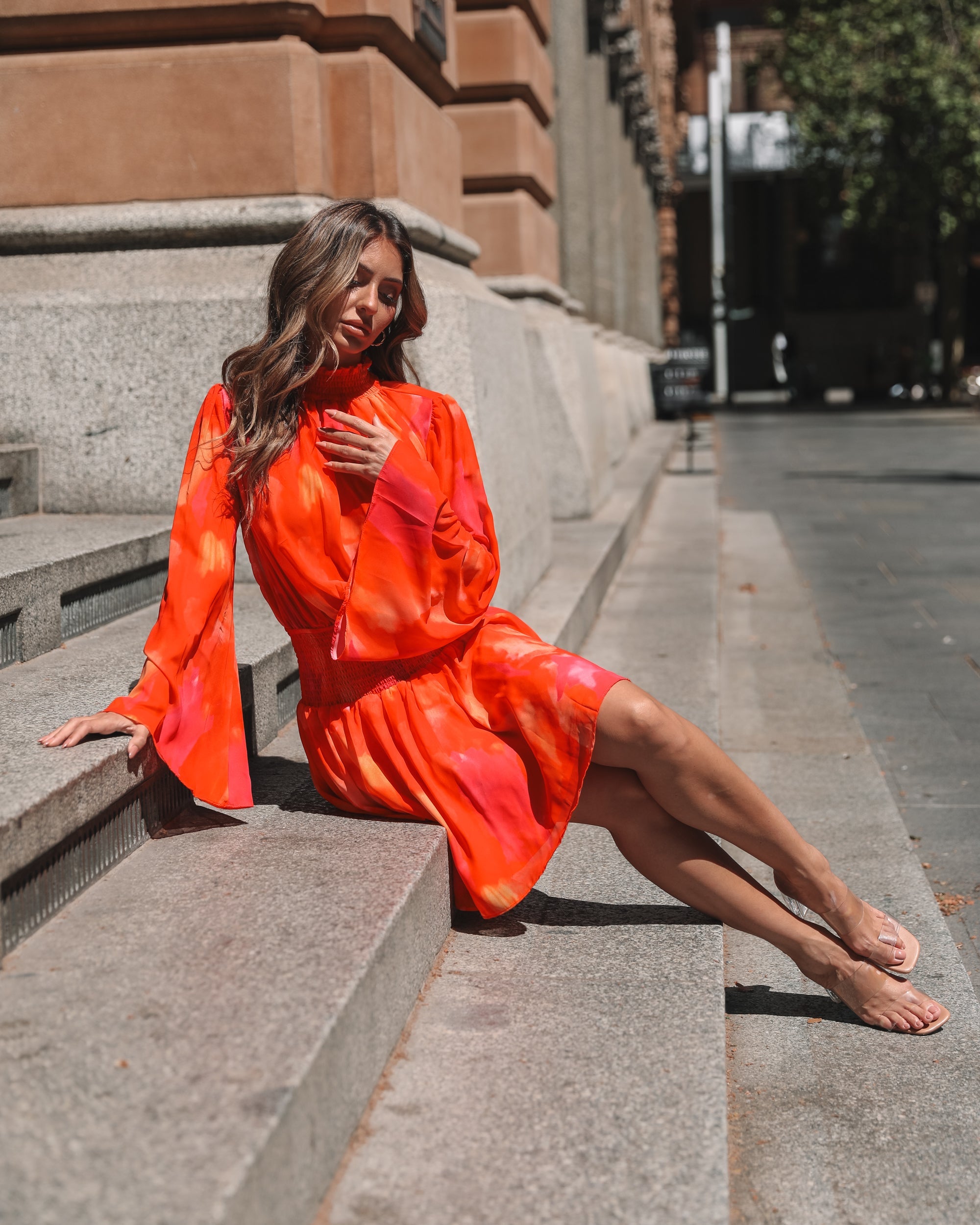 Model wearing the Daenerys Mini Dress in Orange Print showing full outfit styling