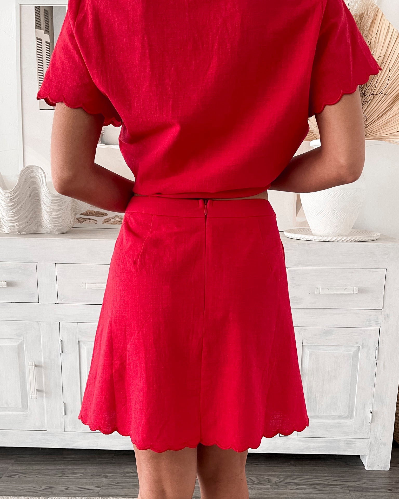 Women's bright red high-waisted mini skirt side view by Esther & Co