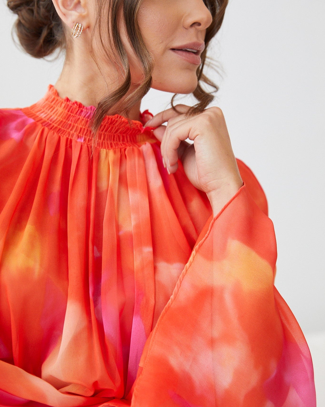 Close up detail of the Daenerys Mini Dress in Orange Print showing the vibrant red and purple print on orange base