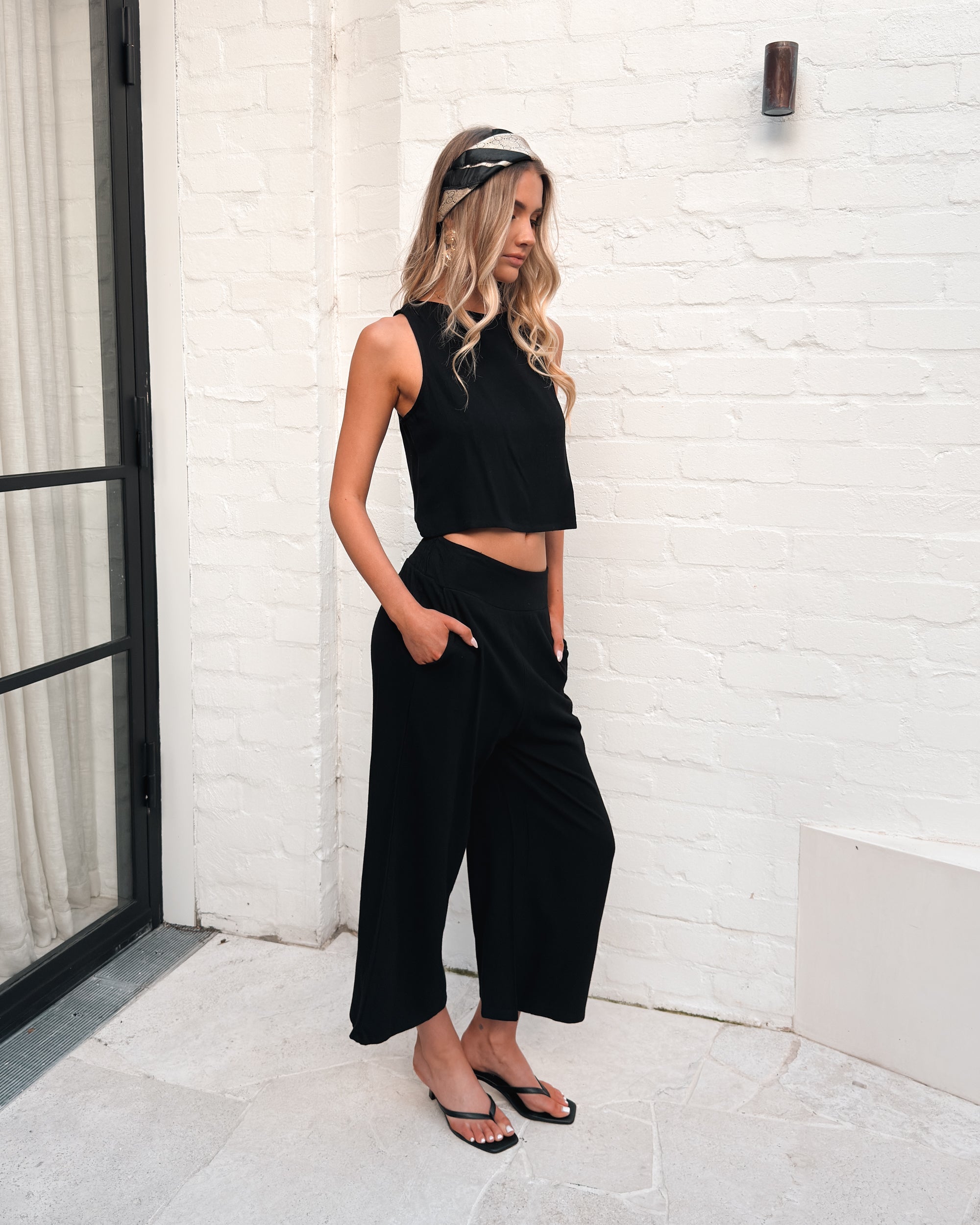 Women's high waisted black linen wide leg pants styled for everyday wear by Esther & Co