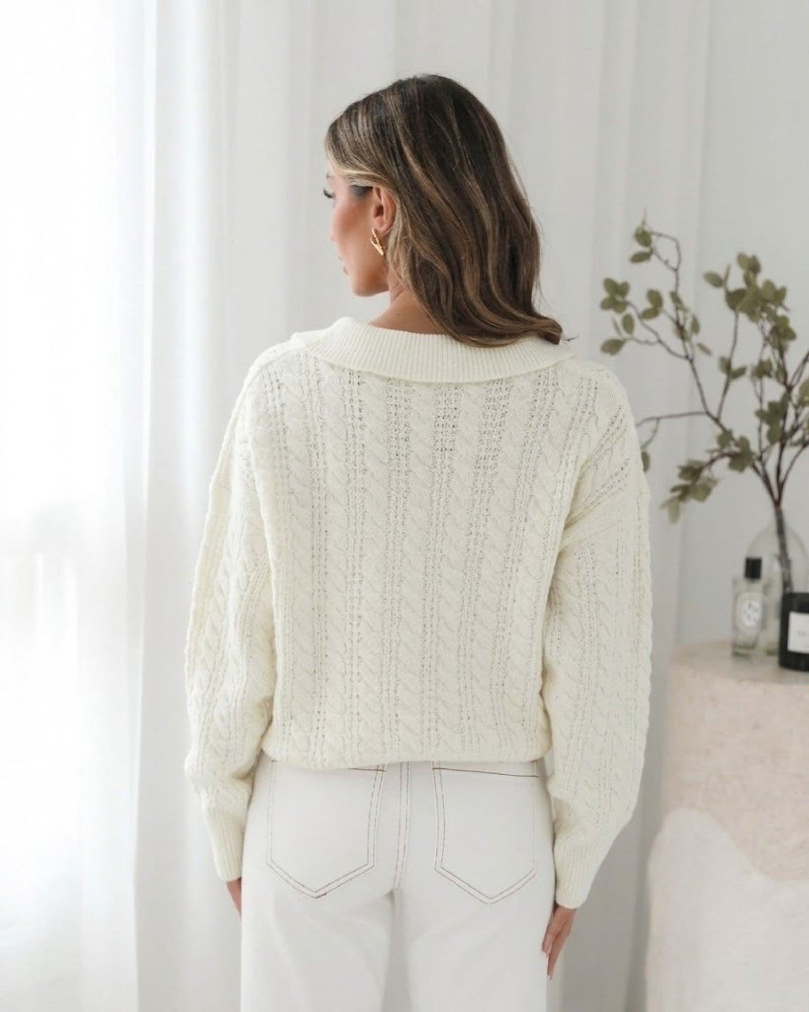 Close-up of cream cable knit and ribbed cuff