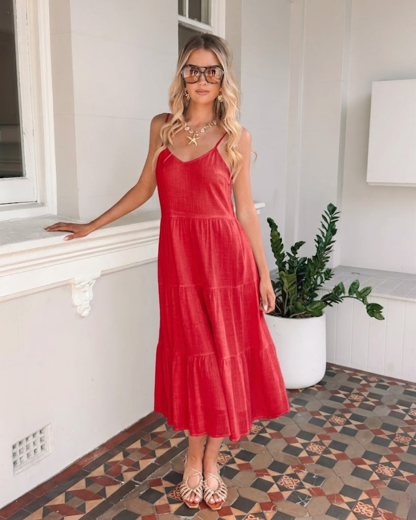 Sonya cherry red linen midi dress with V neckline and adjustable straps, side view