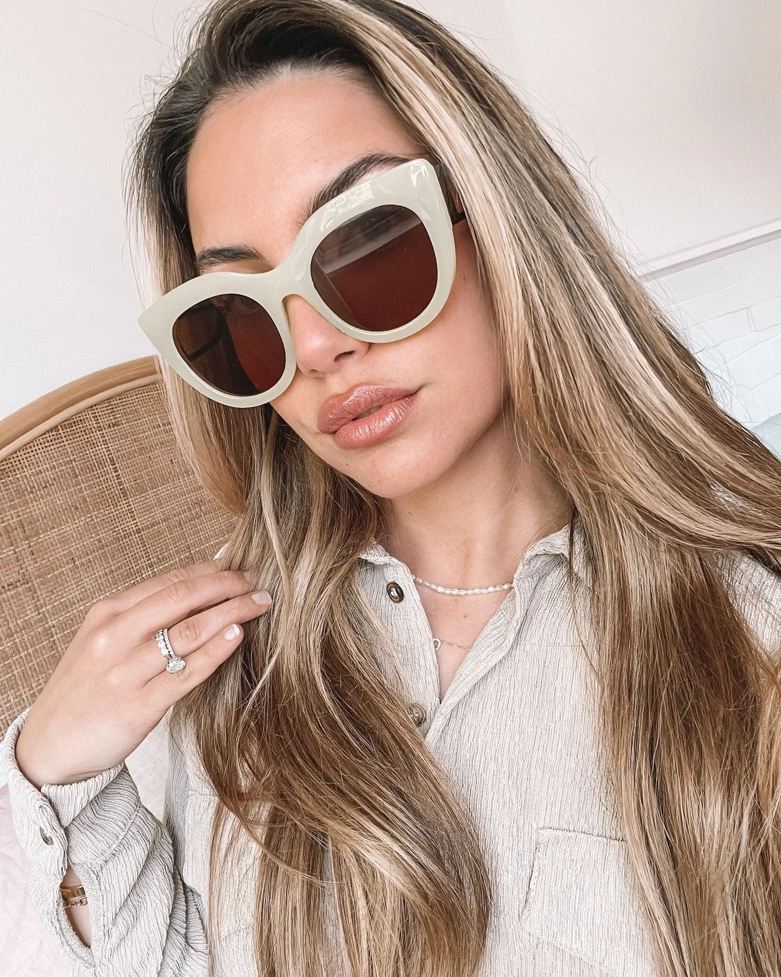 A pair of sunglasses with green frames and brown lenses displayed on a surface.