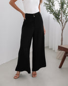Women's black high waisted wide leg trousers front view by Esther & Co