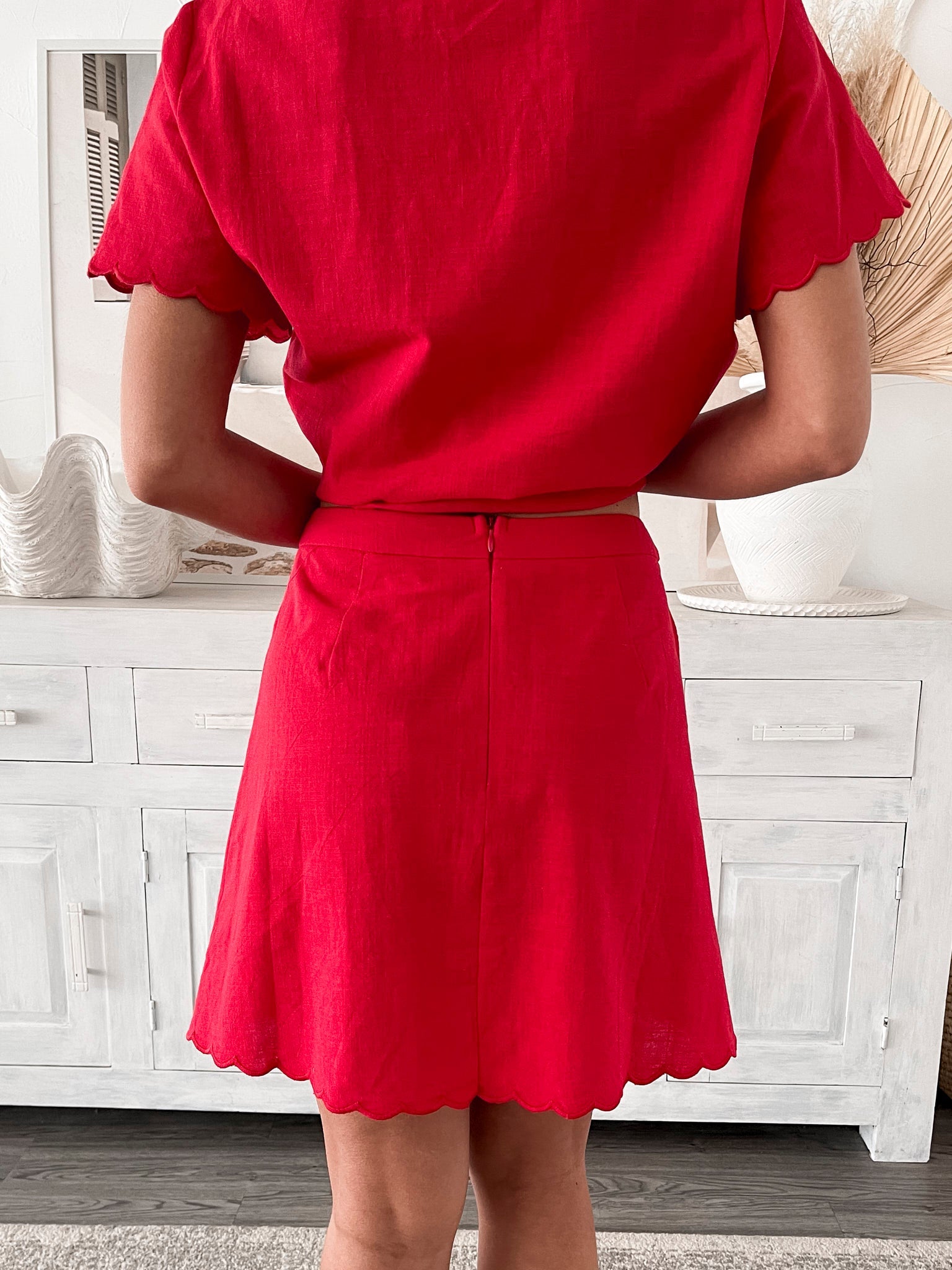 Women's bright red high-waisted mini skirt side view by Esther & Co