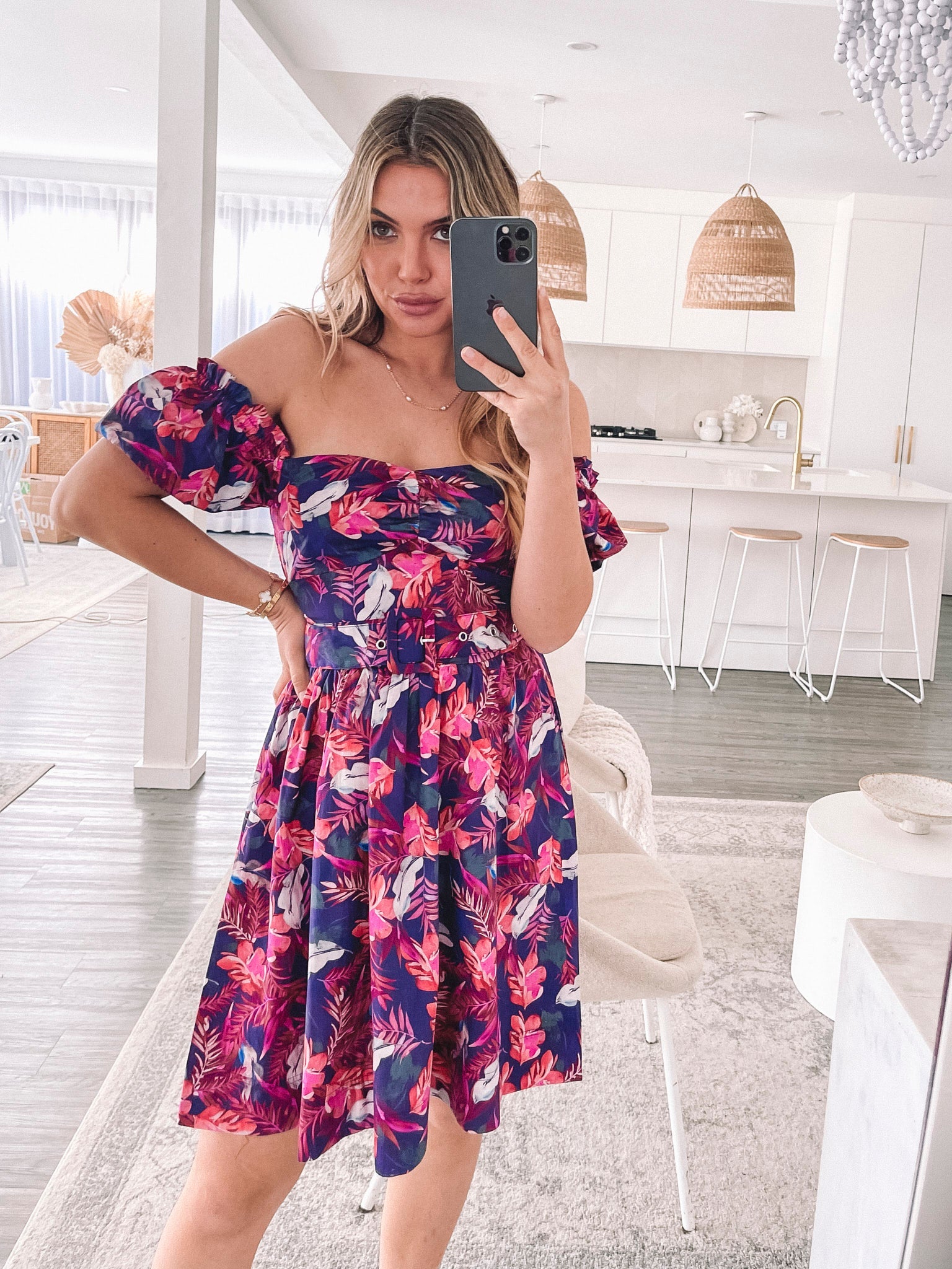 Women's flowy purple print mini dress styled for a garden party by Esther & Co