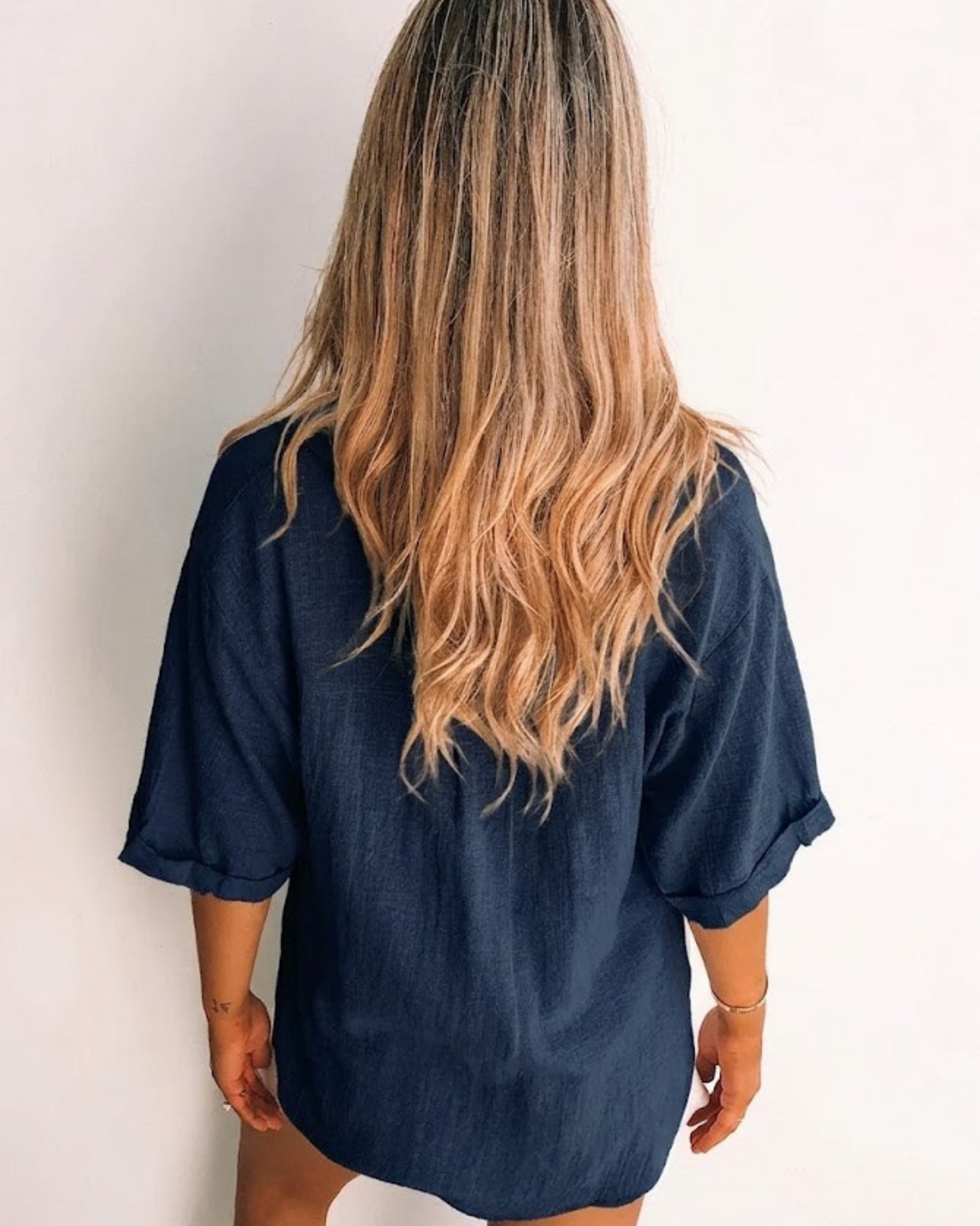 Fraise navy linen blouse with V neckline and button front, styled view