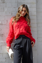 Front view of the Hadi Knit Red showing the high round neckline and relaxed textured knit