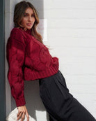 Side view of the Hadi Knit in Wine showing the long sleeves and relaxed fit