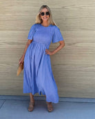 Women's flowy blue cotton dress styled for a garden wedding by Esther & Co