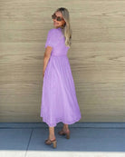 Women's flowy lavender cotton dress styled for a garden party by Esther & Co