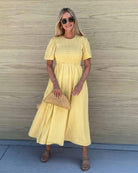 Women's yellow cotton midi dress with shirred bodice and flutter sleeves, the Iolana Dress in Sunshine by Esther & Co