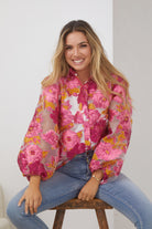 Janette Shirt in Pink Floral pink embossed floral blouse with bishop sleeves side view