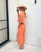 Lighthouse rust cropped wide-leg linen pants, side view