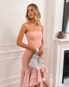Elegant woman in a pink strapless dress with a ruffled hem, perfect for weddings, formal events, evening balls, and special occasions, standing gracefully.