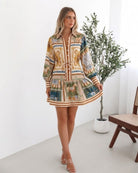 Women's bold print tiered mini dress styled for brunch by Esther & Co