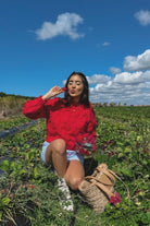 Hadi red knit jumper worn with denim