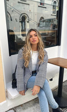 Model wearing the Polaris Plaid Print Coat styled with tailored trousers and heels for a races-ready look