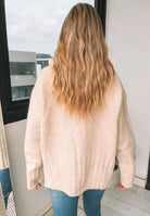 Side view of the Chesterfield Jumper in Beige showing the textured mocha speckle knit fabric
