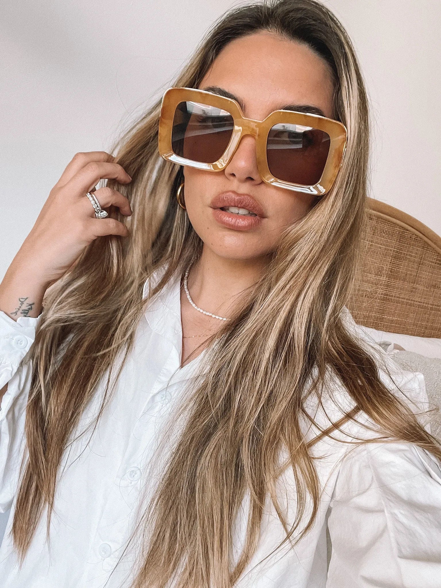 A pair of sunglasses with a tan frame displayed on a surface.